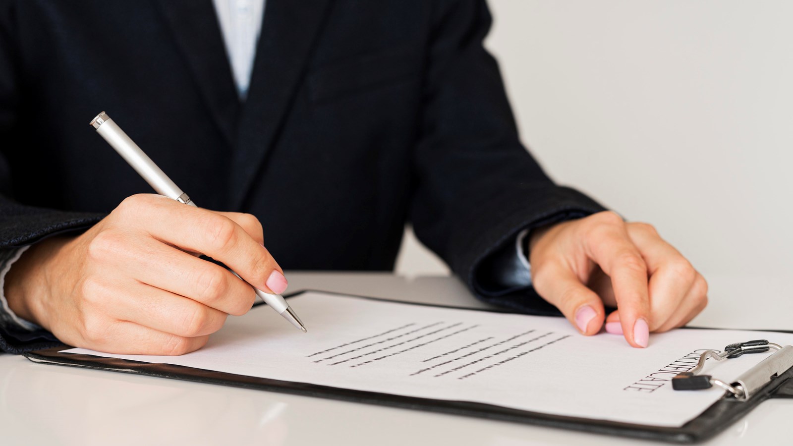 person-signing-certificate-front-view.jpg